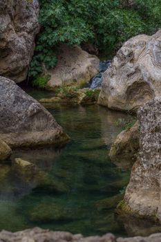 swimming pools with a small waterfall in a mountain river with cold and crystalline waters.