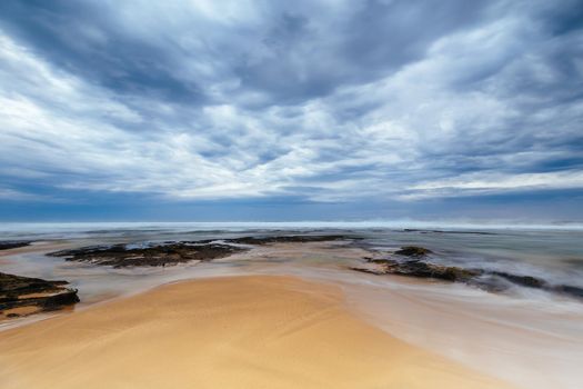 Boag Rocks at Gunnamatta Ocean Beach on a stormy afternoon in St Andrews Beach in Victoria, Australia