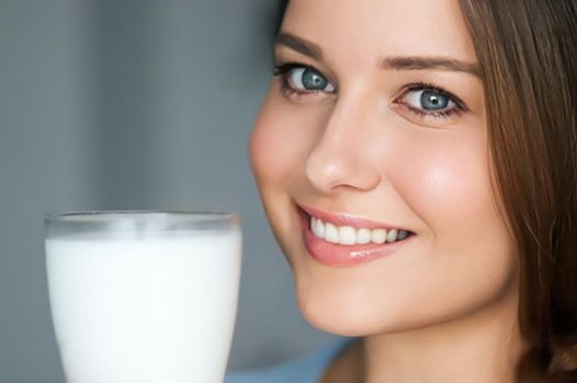 Diet and wellness, young woman with glass of milk or protein shake cocktail, portrait
