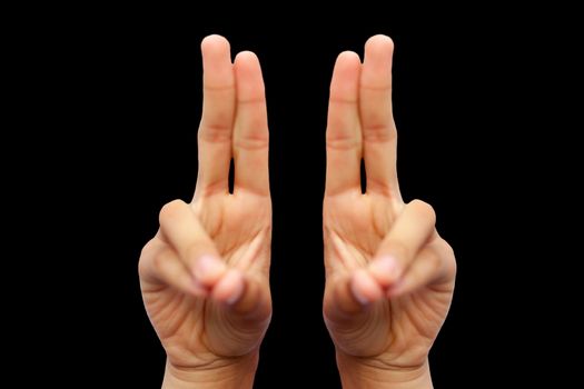 Isolated pair of male hands demonstrating Kapitthaka Mudra isolated on a black colored background. Vertical shot of Kapitthaka Yoga Mudra.