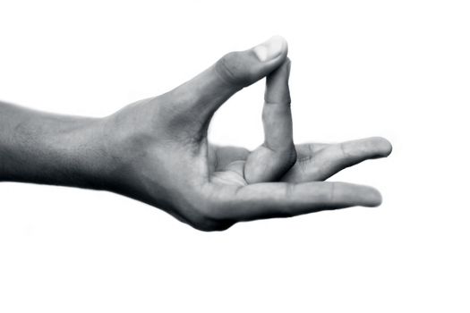 Human hand doing Akash Yoga Mudra isolated on a white-colored seamless background. Shot of single-hand demonstrating Akash Mudra.