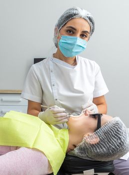 Dentist Examining Patient's Mouth with dental mirror In Clinic. Checkup concept