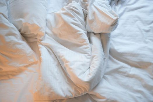 messy bed in early morning , messy bed after waking up .