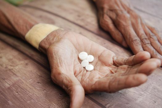 top view of senior women taking pills .