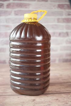 Mustard oil in a plastic jar on table . High quality 4k footage