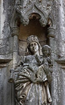 Eroded church building statue with Mary's child. Budapest, Hungary Vajda Hunyad Castle.