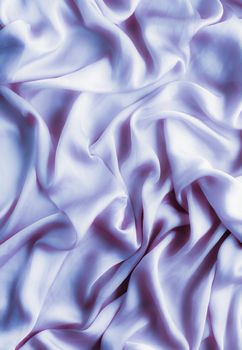 Elegant fabric texture, abstract backdrop and modern pastel colours concept - Purple soft silk waves, flatlay background