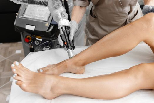 the process of laser hair removal of legs in a large palm. Hair removal with laser