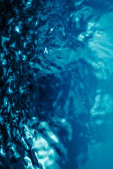 Abstract blue liquid surface as background - futuristic design and science concept. Deep blue waters