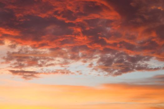 Beautiful orange and yellow clouds at sunrise and sunset in the sky