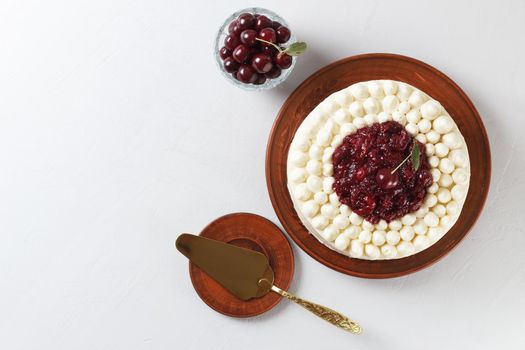 Biscuit cake, cherry souffle with cream cheese and cherry confiture on a gray background. copy space