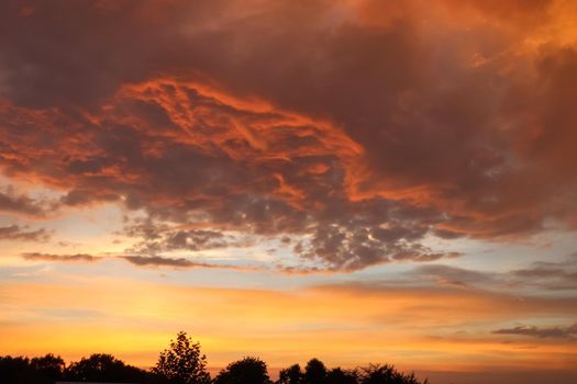 Beautiful orange and yellow clouds at sunrise and sunset in the sky