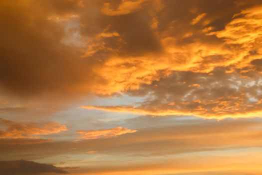 Beautiful orange and yellow clouds at sunrise and sunset in the sky