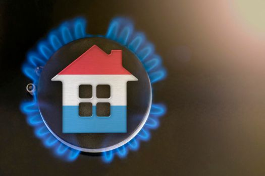 gas crisis. Rising utility costs in Luxembourg. Energy crisis, export-import problems in Luxembourg. The concept, gas burner and house model are colored in the colors of the flag