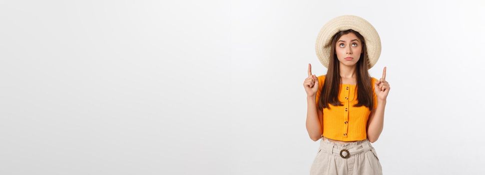 young pretty woman looking unhappy and stressed, suicide gesture making gun sign with hand, pointing to copy space