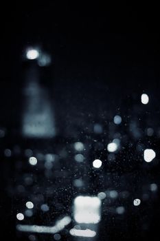 Big metropolitan city lights at night, blurry background - night life, abstract background and modern dark tones concept
