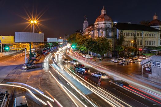 A long exposure night shot of a Yangon main street with beautiful buildings in Myanmar