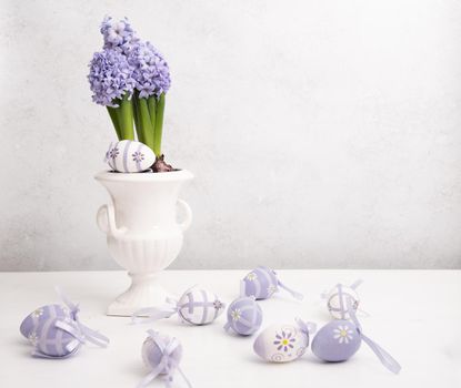 Easter eggs and Lilac hyacinth in a vase, spring still life, copy space. High quality photo
