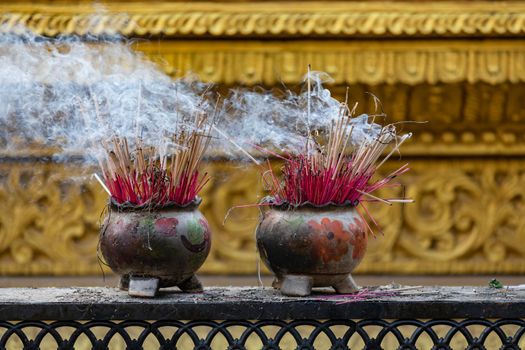 Incense sticks in the Temple of the Four Seated Buddhas of Kyaikpu in Bago
