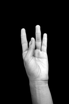 Isolated hands of a male doing Shunya Mudra or Mudra of Emptiness on a black colored background, studio shot.