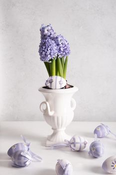 Easter eggs and Lilac hyacinth in a vase, spring still life, copy space. High quality photo