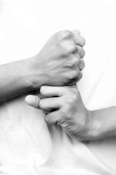 Shot of pair of human hands doing Vajra Yoga Mudra isolated on white background. Vertical shot of hands demonstrating Vajra Mudra.