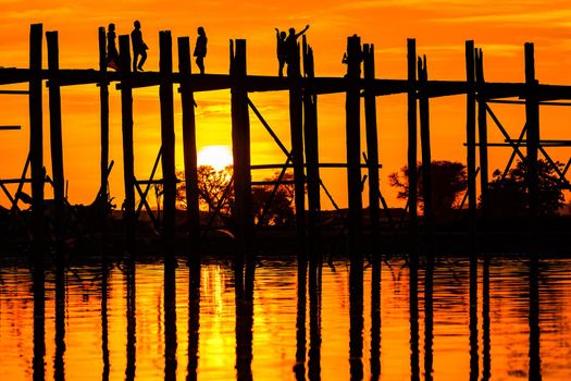Sunset behind the longest teak bridge in the world in Myanmar