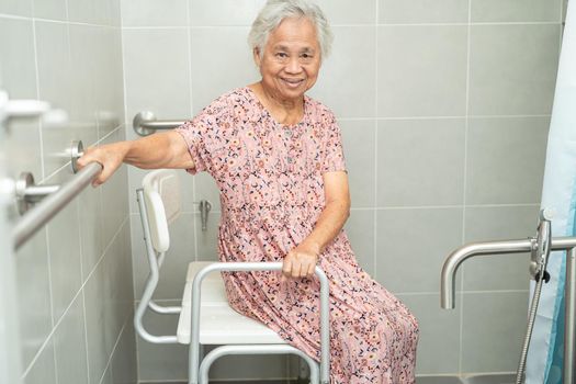 Asian senior or elderly old lady woman patient use toilet bathroom handle security in nursing hospital ward, healthy strong medical concept.