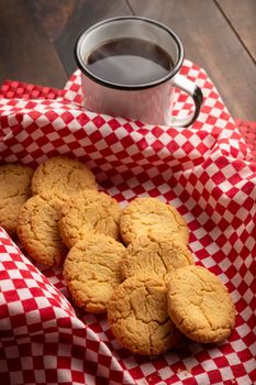 Homemade crunchy cookies and a coffee cup on wooden rustic table
