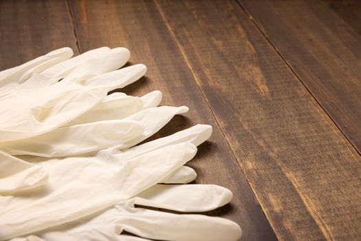 medical latex gloves for protection on wooden background. Useful for pandemic prevention concept