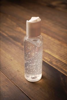 pocket hand sanitizer bottle on wooden background, useful for COVID19 pandemic concept