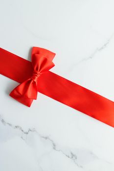 Holiday decor, feminine design and flatlay concept - Red silk ribbon on marble, top view