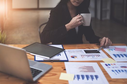 Close-up of a businesswoman using a calculator to audit the company's budget. Tax information is calculated by accountants