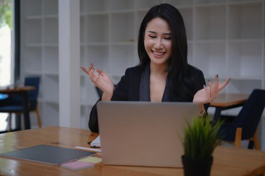 During a video conversation with her business team, a businesswoman discusses the stock market and the concept of working from home.