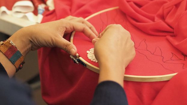 Woman hands and craft work. Embroider sewing by hand. Handicraft work by thread needle sew knit. Wood frame embroidery hoop. Needlework handicraft crafting quarantine leisure concept. 