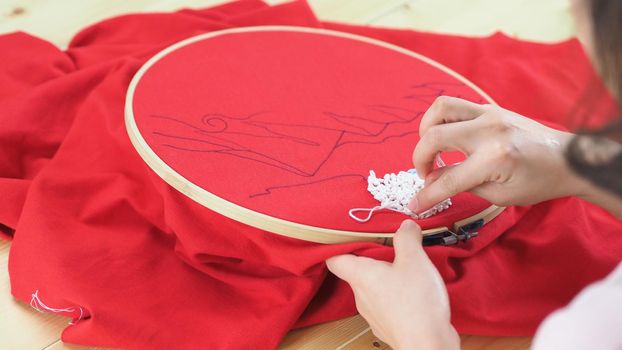 Woman hands and craft work. Embroider sewing by hand. Handicraft work by thread needle sew knit. Wood frame embroidery hoop. Needlework handicraft crafting quarantine leisure concept. 