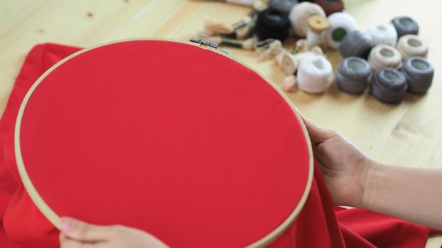 Woman hands and craft work. Embroider sewing by hand. Handicraft work by thread needle sew knit. Wood frame embroidery hoop. Needlework handicraft crafting quarantine leisure concept. 