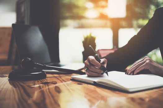 Close up lawyer businessman working or reading lawbook in office workplace for consultant lawyer concept.