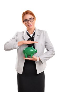 Beautiful smiling businesswoman holding a green piggy bank, isolated on white background. Finance, banking, loan, savings concept.