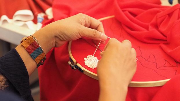 Woman hands and craft work. Embroider sewing by hand. Handicraft work by thread needle sew knit. Wood frame embroidery hoop. Needlework handicraft crafting quarantine leisure concept. 