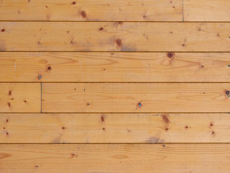 Authentic wood planks in the wall of cabin, texture of spruce wood board