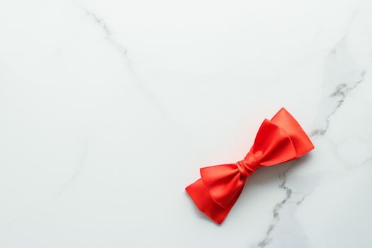 Holiday decor, feminine design and flatlay concept - Red silk ribbon on marble, top view