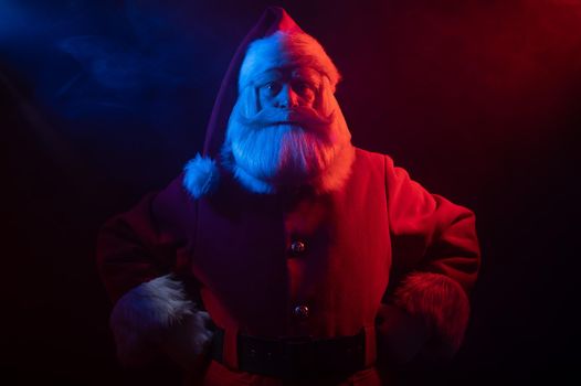 Santa Claus portrait in blue red neon light and smoke