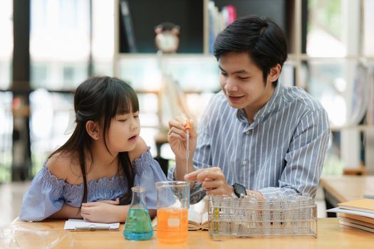 Kid and father doing science experiments. Education science concept.