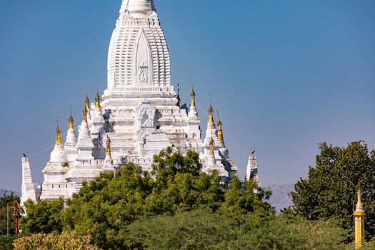 Richly decorated white temple in the large temple complex of Bagan in Myanmar