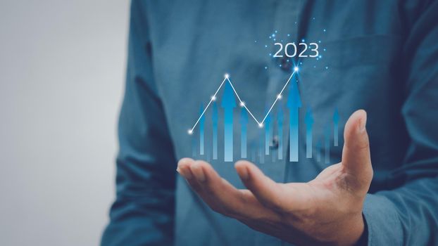 Businessman increase arrow graph corporate future growth New Goals Plans and Visions for Next Year 2023.Business finance economic development investment.