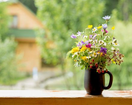 bouquet of wild flowers on a wooden background