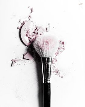 Beauty texture, cosmetic product and art of make-up concept - Brush with crushed eyeshadow and powder close-up isolated on white background