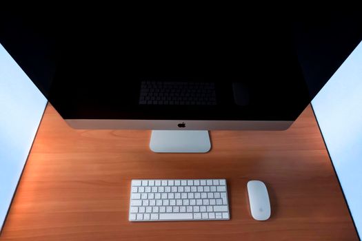 modern workplace: monoblock, wireless mouse and Apple keyboard