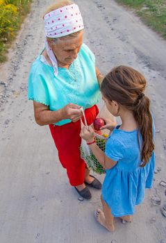 Child and grandmother carry vegetables in a bag. Selective focus. Food.